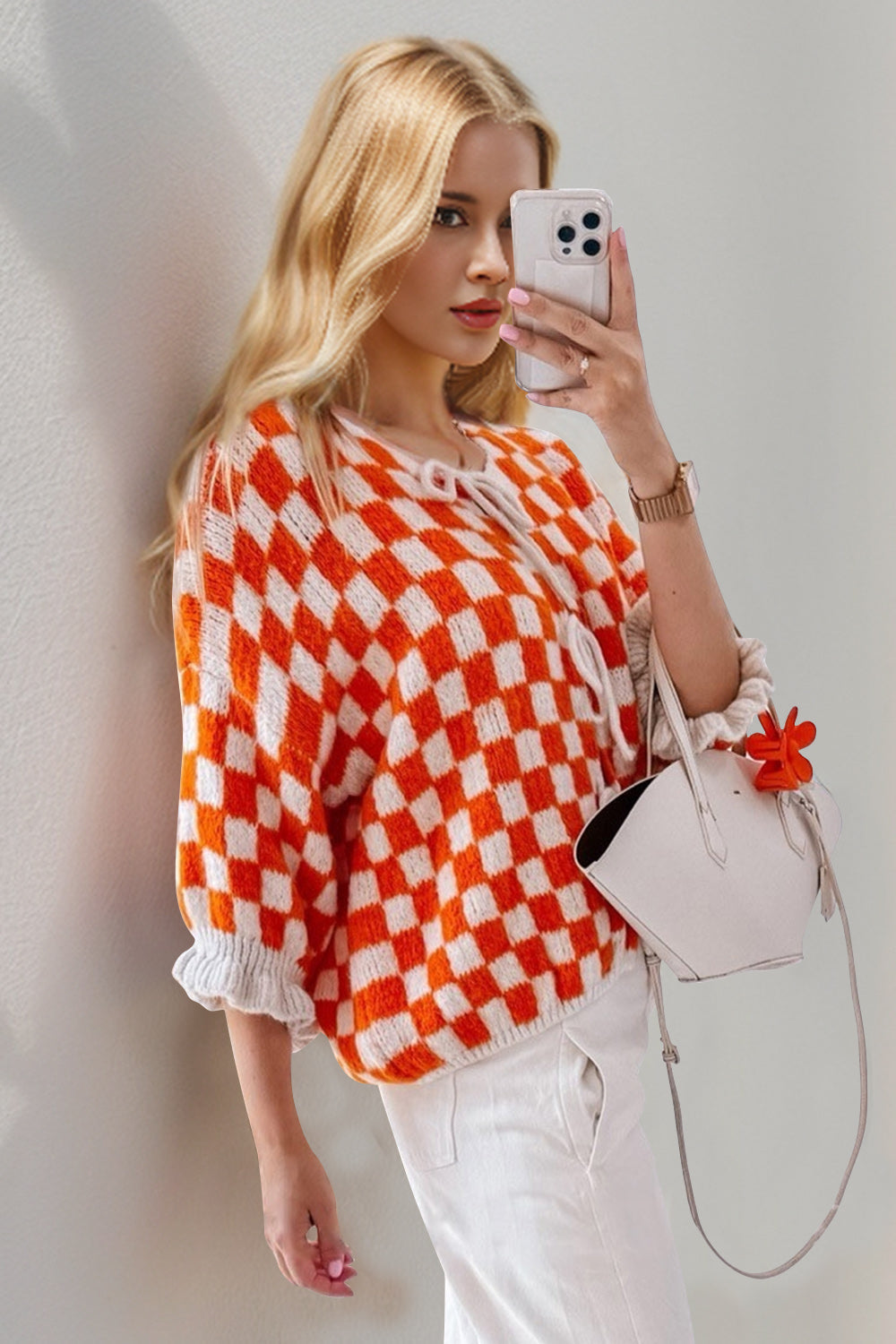 Orange and white checkered knit cardigan with tie front and ruffle sleeves
