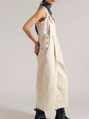 Beige denim overalls with wide legs, button-down sides, and raw hem.