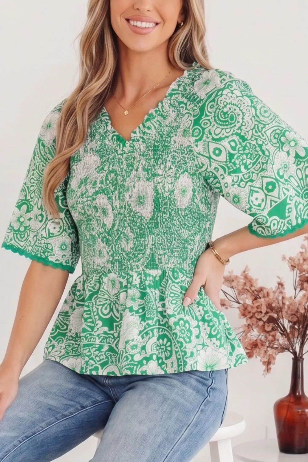 Green floral smocked v-neck peplum top with ruffled sleeves