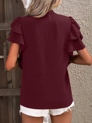 Burgundy ruffled sleeve blouse with a plunge neckline.