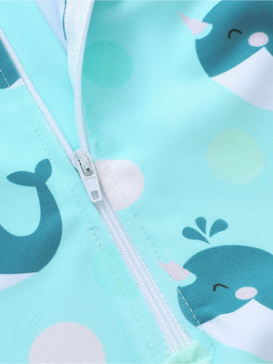 Children's swimwear set in turquoise with a whale print and polka dots, featuring a front zipper.