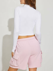White high-neck cropped active zip top with long sleeves.