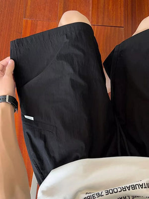 Black relaxed fit drawstring shorts with a small white tag detail on the pocket.