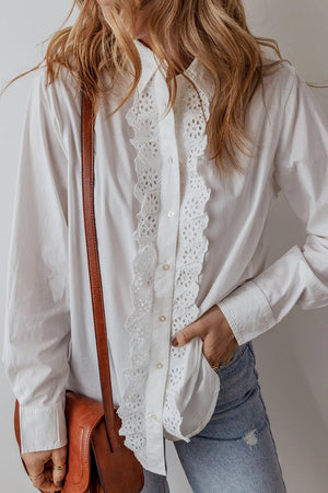 White cotton shirt with eyelet ruffle front detail and button closure.