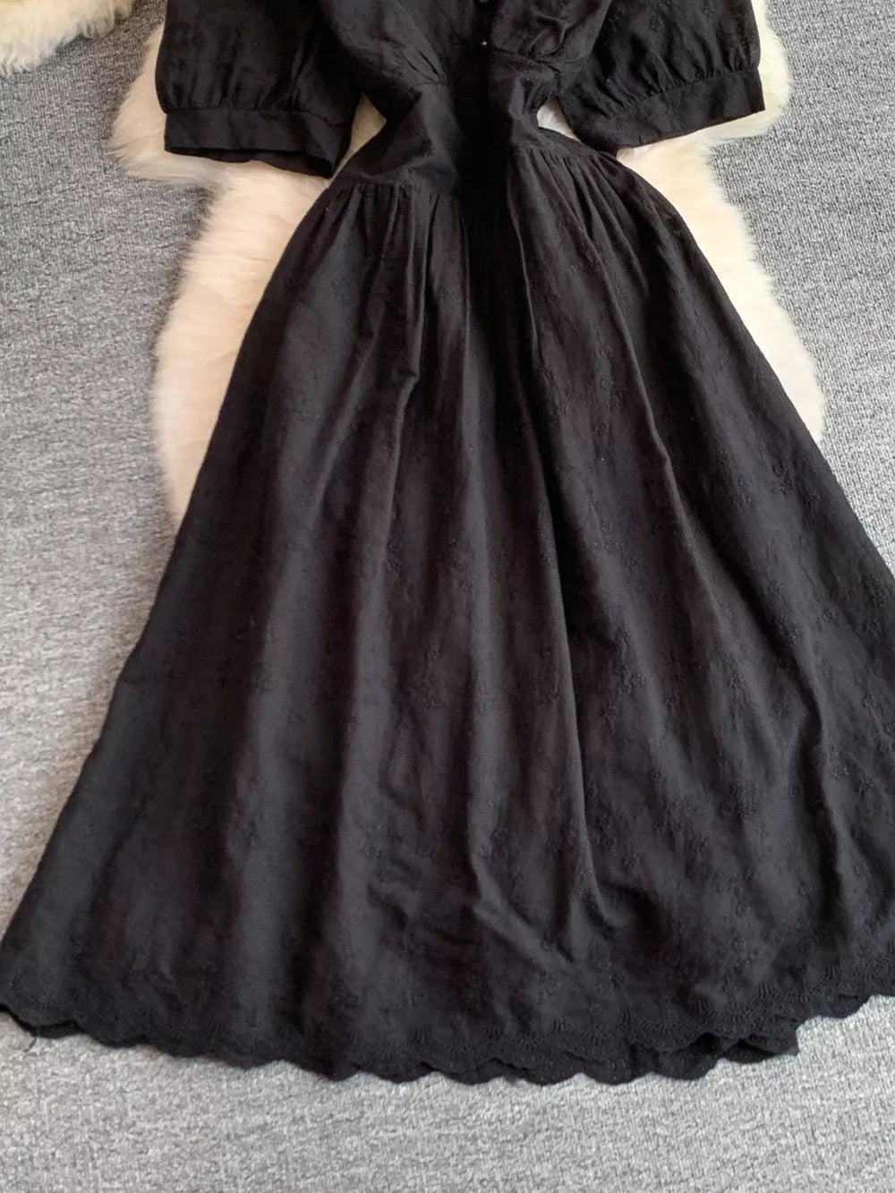 Black lace-embellished A-line midi dress with scalloped hem and button detail