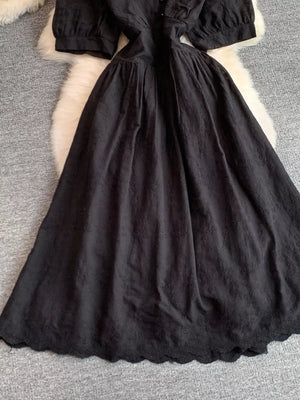 Black lace-embellished A-line midi dress with scalloped hem and button detail