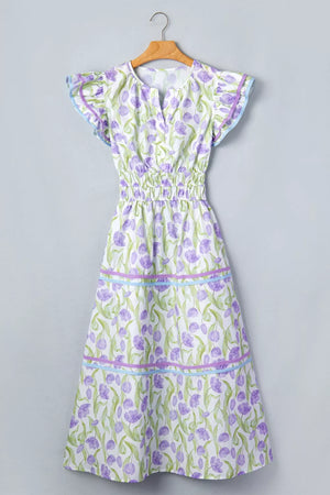 Lavender tulip print midi dress with smocked waist, flutter sleeves, and tiered skirt with ribbon trim.