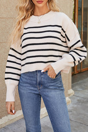 Boxy ribbed knit sweater in cream with black stripes, crewneck, and long sleeves.