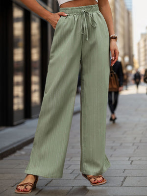 Sage linen blend palazzo trousers with drawstring waist and subtle vertical pinstripe detail.