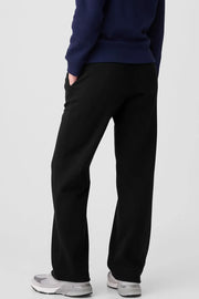 Black relaxed-fit lounge trousers with drawstring waist and pockets.