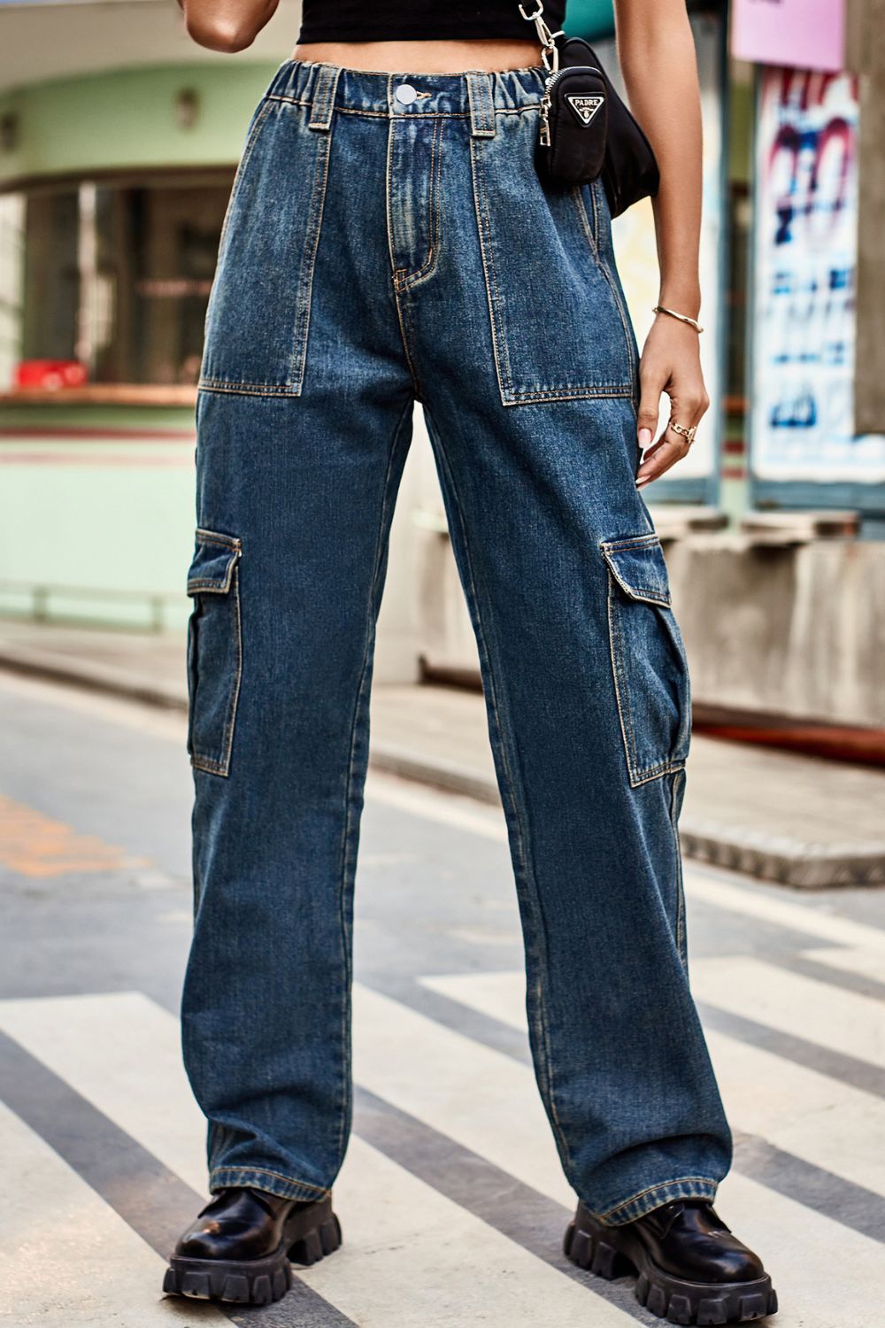 Relaxed fit dark wash denim cargo pants with multiple pockets and a comfortable casual style.