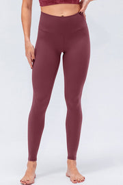 Burgundy high-rise performance leggings with a V-waistband.