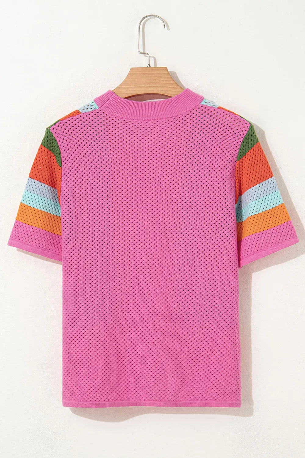 Pink openwork knit t-shirt with multicolor geometric stripe sleeves.