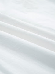 White cotton eyelet embroidered sheer shirt with button-down detail.