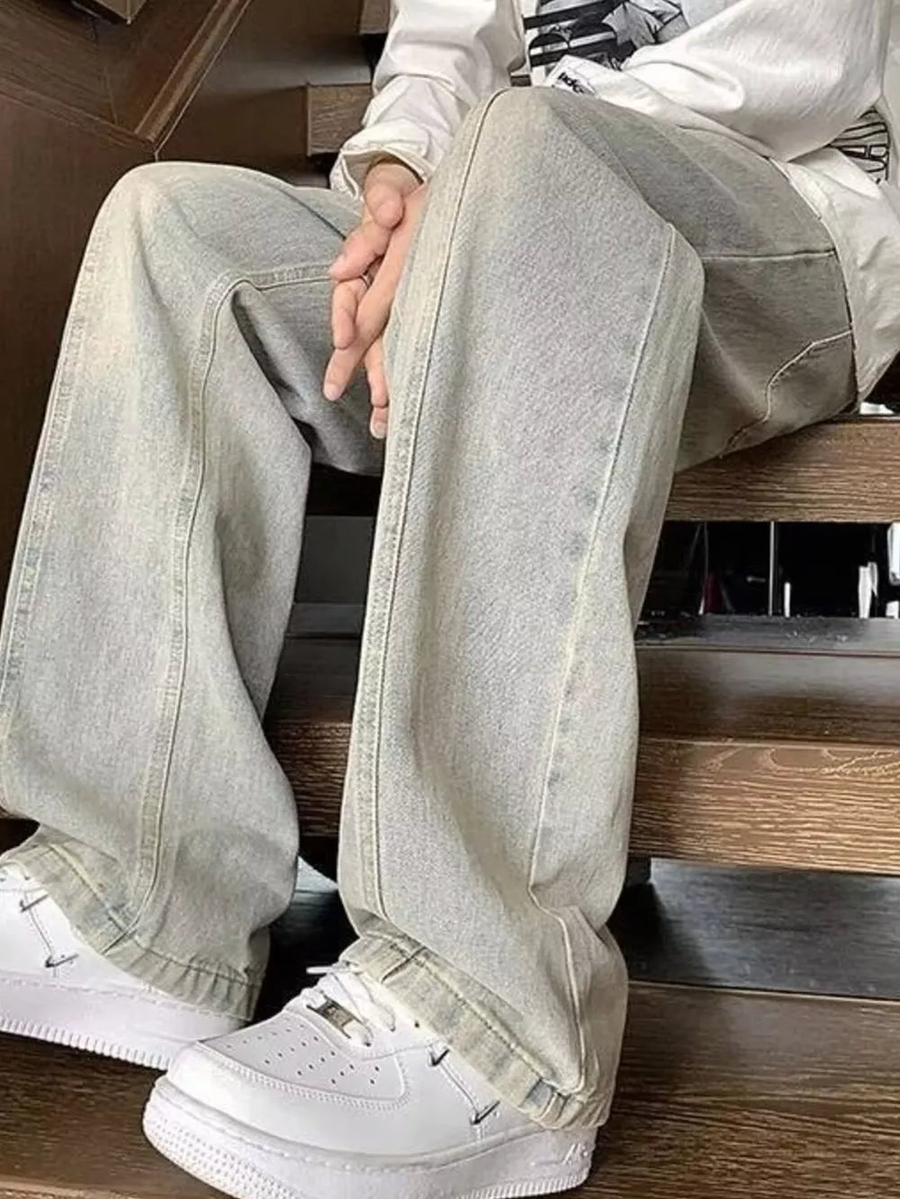 Men's light gray distressed cotton jeans with oversized fit and relaxed leg.