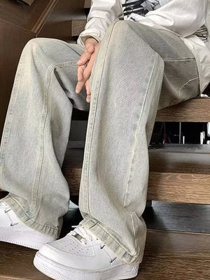 Men's light gray distressed cotton jeans with oversized fit and relaxed leg.