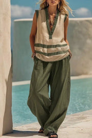 Moss green flowy pants and a striped V-neck sleeveless top with green trim