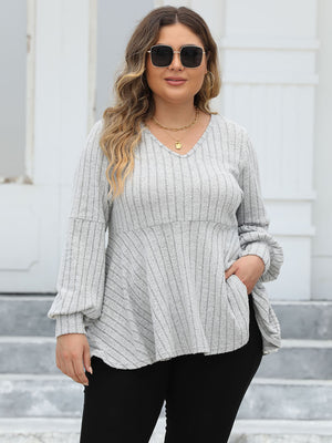 Light gray ribbed peplum blouse with blouson sleeves and v-neck.