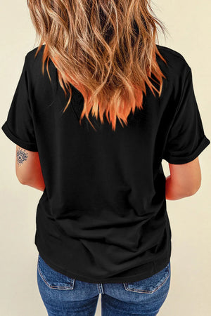 Black graphic t-shirt with rolled sleeves and an abstract eye tattoo on the arm.