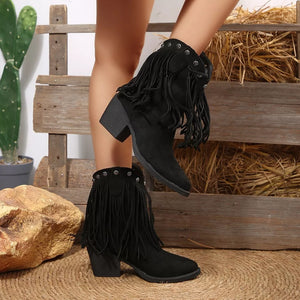 Black suede western boots with fringe and decorative studs on block heels.