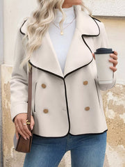 Beige double-breasted bolero jacket with black contrast trim and gold buttons.