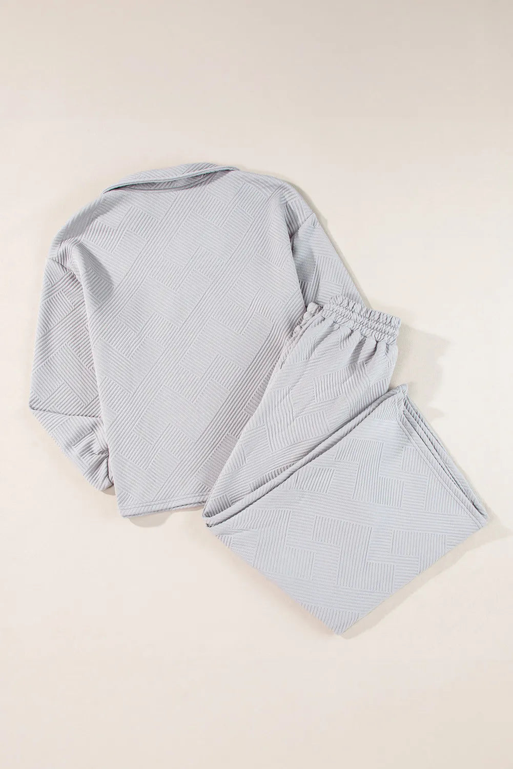 Gray textured quilted knit loungewear set with collared top and elastic waist pants.
