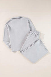 Gray textured quilted knit loungewear set with collared top and elastic waist pants.