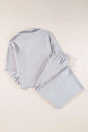 Gray textured quilted knit loungewear set with collared top and elastic waist pants.