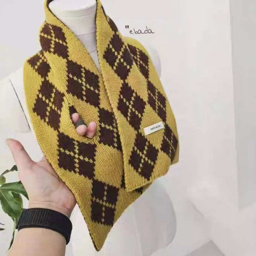 Cozy argyle pattern wool scarf in brown and yellow with a hand passing through a loop.