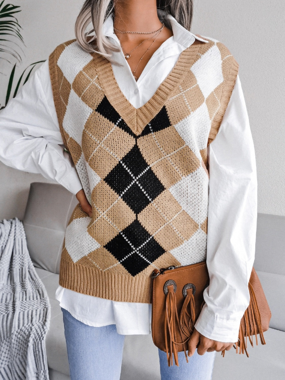 Argyle knit v-neck sweater vest in tan, white, and black acrylic.