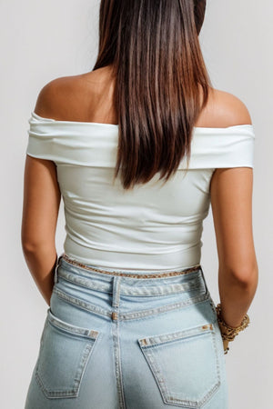 White off-the-shoulder sculpted bodice top with a bare back and casual styling.