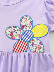 Lavender cotton toddler dress with ruffled hem and a colorful patchwork flower appliqué.