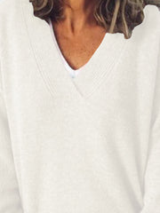 Ivory ribbed knit sweater with V-neck, layered over a white tee.