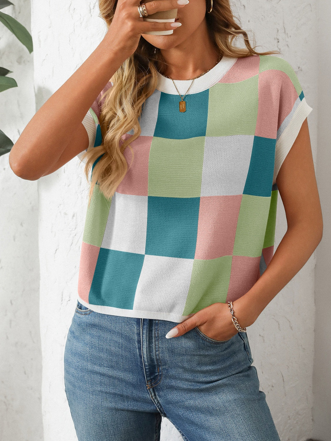 Checkerboard knit cap sleeve top in pastel pink, green, blue, and white.
