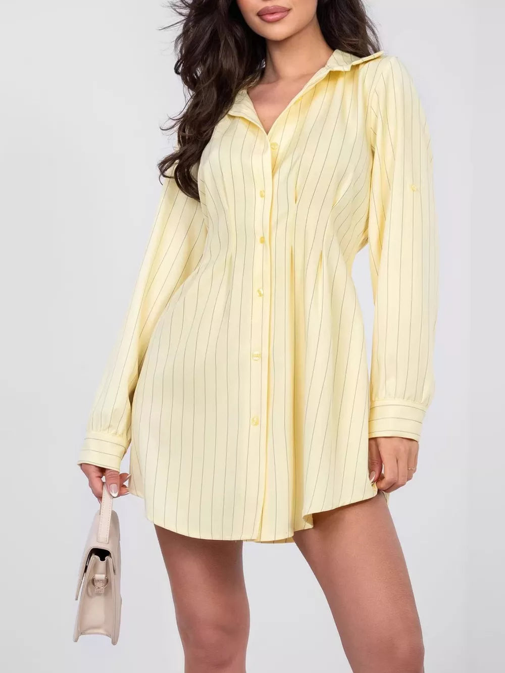 Light yellow pinstripe mini shirt dress with button detail and collared neckline.