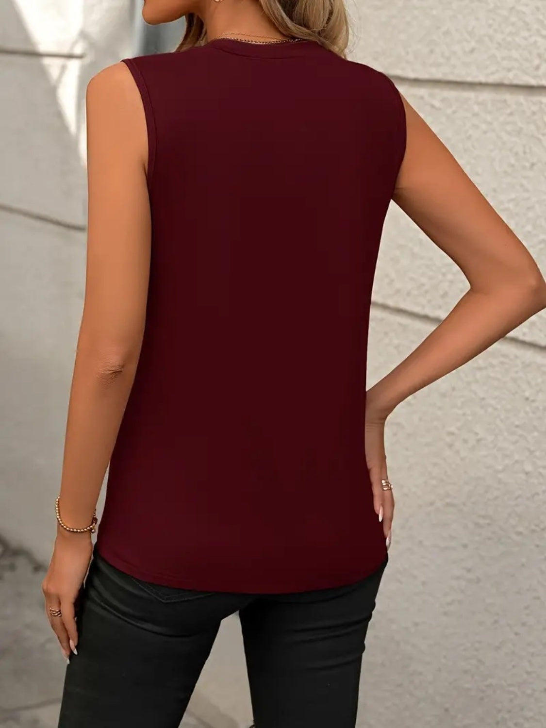 Burgundy sleeveless tank top with diagonal seam detail and crew neck.