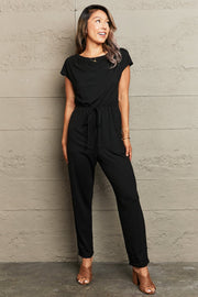 Black cap sleeve jumpsuit with drawstring waist and boat neck