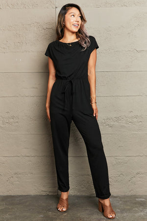 Black cap sleeve jumpsuit with drawstring waist and boat neck