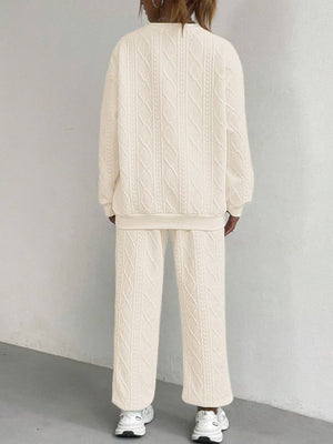 Beige cable knit lounge set with crewneck sweatshirt and wide-leg pants.