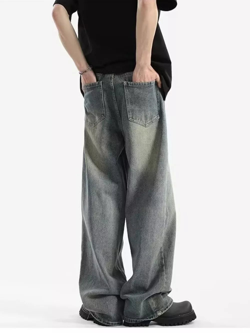 Men's relaxed fit vintage wash jeans with baggy legs and distressed detailing.