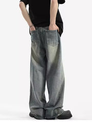 Men's relaxed fit vintage wash jeans with baggy legs and distressed detailing.