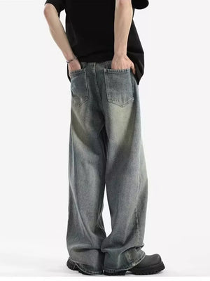 Men's relaxed fit vintage wash jeans with baggy legs and distressed detailing.
