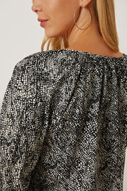 Black serpentine print blouse with gathered neckline and sleeves.