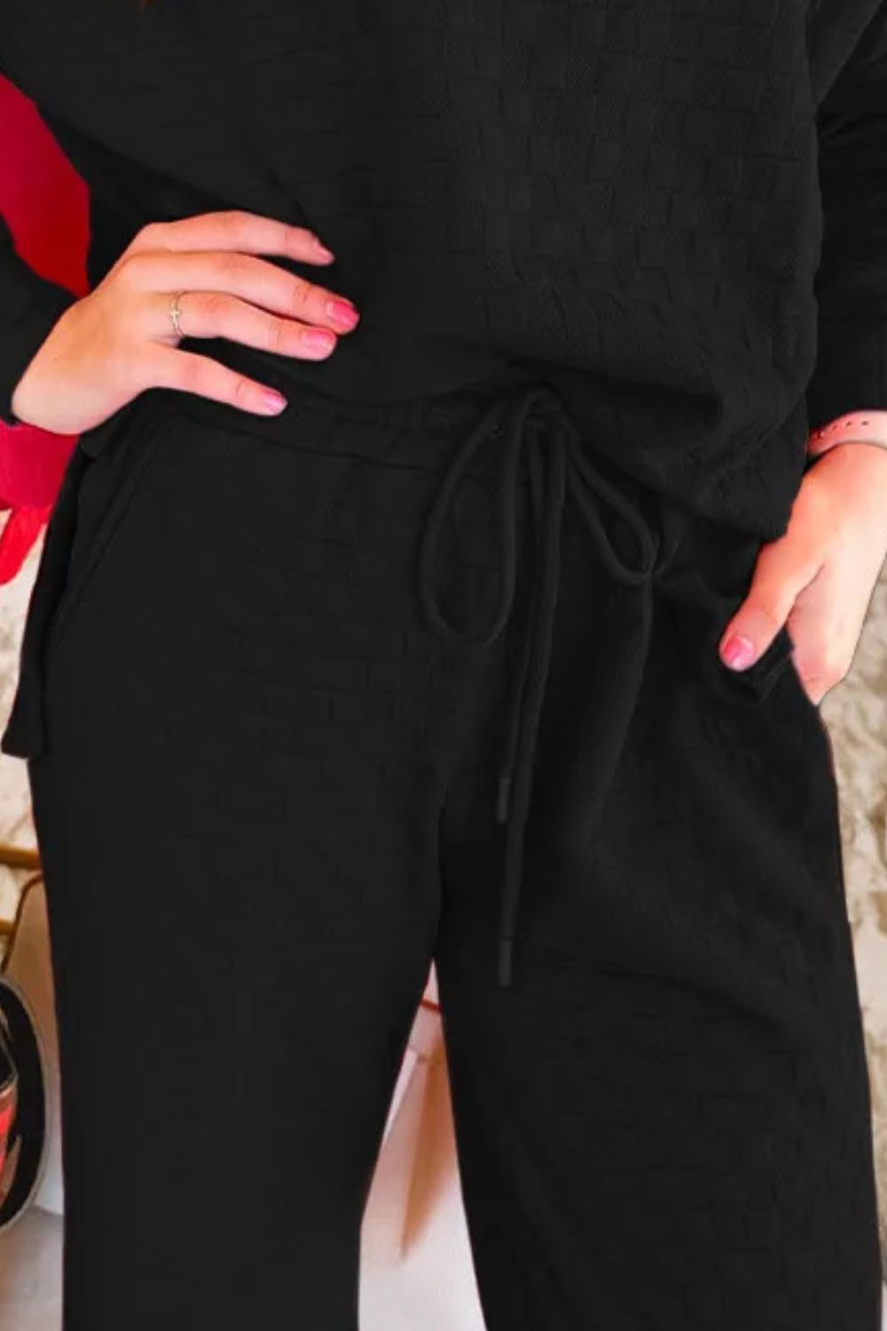 Black textured weave lounge set with drawstring waist and pockets.