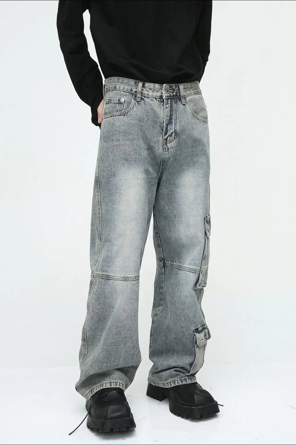 Medium wash wide leg cargo jeans with utility pockets and a relaxed fit.