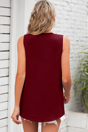 Burgundy textured sleeveless blouse with a curved hem.