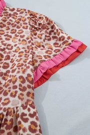 Leopard print dress with ruffled short sleeves in pink and red trim.
