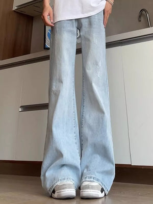 Men's light blue distressed full-length flare jeans with a cotton blend fabric.