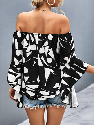 Black and white geometric print off-shoulder blouse with flared bell sleeves.