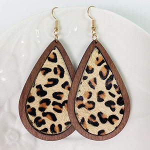 Leopard print teardrop wood earrings with gold hooks.